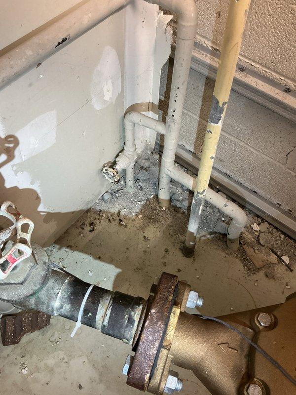 Responded to emergency call for a burst pipe in a commercial facility showing active water discharge. Located and repaired the damaged section of PVC piping in the utility area, which showed significant corrosion at the bronze valve connection point. Secured the repaired pipe with proper mounting brackets, verified system integrity, and confirmed no residual leakage after restoration of water service.