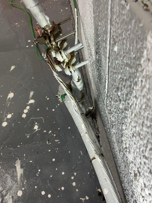 Responded to emergency call for a burst pipe in a commercial facility showing active water discharge. Located and repaired the damaged section of PVC piping in the utility area, which showed significant corrosion at the bronze valve connection point. Secured the repaired pipe with proper mounting brackets, verified system integrity, and confirmed no residual leakage after restoration of water service.