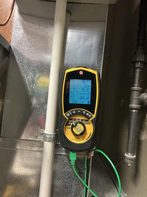 Diagnosed 15-year-old thermostat displaying sensor error code, though system remained operational. Performed diagnostic testing with Fieldpiece C197, recording temperature readings of 89.4°F and 113.5°F at different test points, confirming thermostat failure. Documented condition with photos for warranty processing.