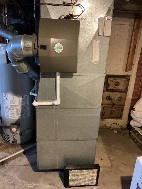 Performed a furnace inspection on a 10+ year old unit located in the basement, confirming tech lead's finding of a cracked heat exchanger. System consists of a main furnace unit with connected sheet metal ductwork and PVC venting. Replacement is recommended due to safety concerns with the compromised heat exchanger.