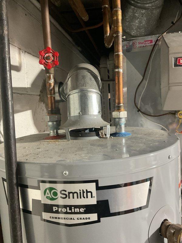 Performed routine maintenance inspection on 10-year-old furnace located in basement. Visual inspection of AO Smith ProLine commercial grade water heater showed proper installation with appropriate copper and galvanized metal piping, ventilation connections, and functioning shut-off valve. Verified furnace ignition system operation with inspection of flame sensors and burner assembly.