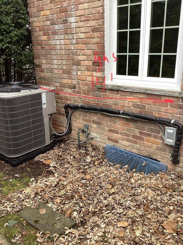 Performed comprehensive generator estimate at residential property, documenting existing HVAC installation with visible refrigerant lines along brick exterior and electrical utility access points. Noted measurement markings (15"-16") on brick wall near electrical meter that will be relevant for generator placement and connection to home's electrical system.