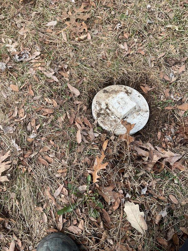 Responded to basement flooding incident in a 1960s home. Inspected the sump pump system and plumbing installation, noting water meter and copper pipe assembly with brass fittings. Identified and cleared drainage blockage affecting the sump pump discharge line, evidenced by the outdoor utility access point where water should properly exit.