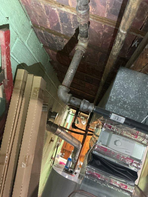 Responded to customer report of gas odor in basement. Performed comprehensive leak detection and identified gas leak at deteriorated copper fitting where black pipe connects to copper elbow joint on green cinder block wall. Completed pressure testing of gas line system, replaced damaged fitting, and verified system integrity with follow-up testing to ensure complete resolution of the leak.