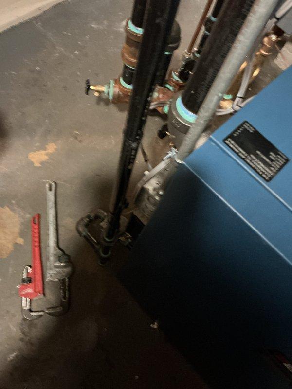 Successfully completed installation of new boiler system with proper plumbing connections. Installed black insulated piping with appropriate fittings and valves, connecting to existing mechanical infrastructure. System was properly mounted against basement wall with all necessary gauges and control mechanisms in place.