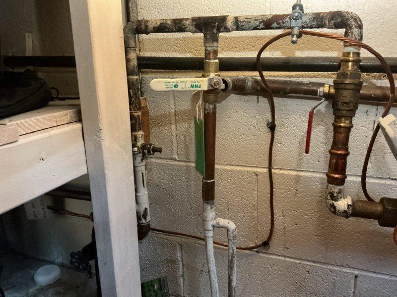 Responded to service call for kitchen faucet making loud noise when turned off and water appearing to run underneath when faucet is off. Diagnosed excessive water pressure as the cause of the hammering noise and leaking issue. Installed pressure regulator valve to normalize system pressure and replaced worn faucet cartridge to resolve the continuous water flow problem.