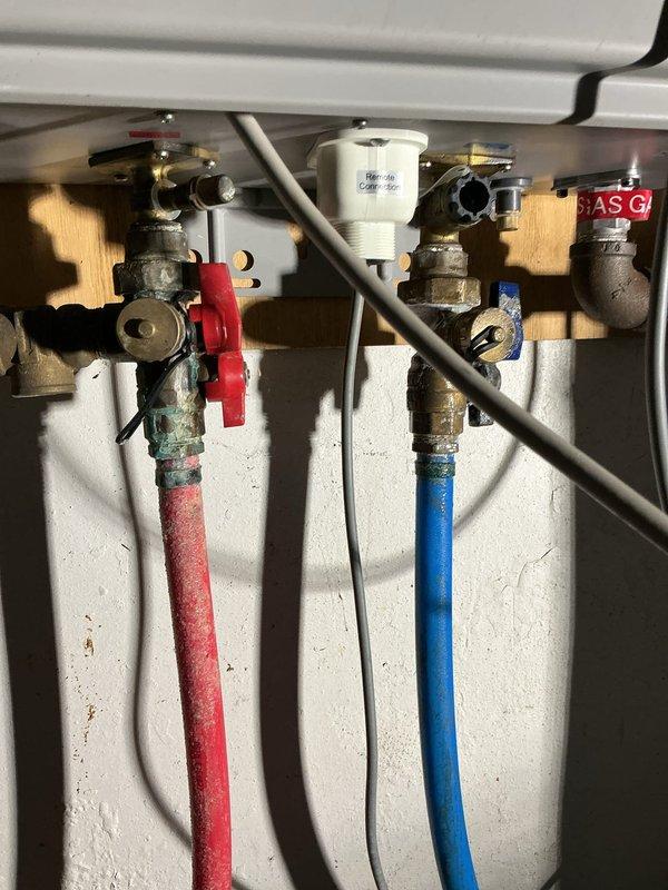 Responded to service call for Rheem tankless water heater displaying error code 88 with no hot water output. Inspected remote connection assembly and removed filter screen for cleaning. Performed descaling procedure on heat exchanger and verified proper operation of hot/cold water lines and gas connection. System functioning normally after service with no error codes present.