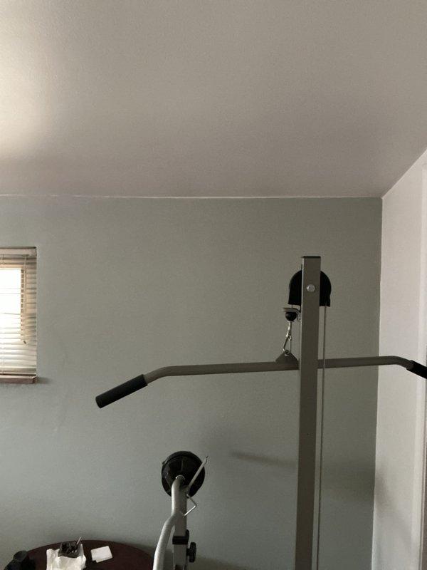 Conducted site evaluation for new mini split installation in living room and bedrooms. Assessed interior wall space for potential indoor unit placement and examined exterior brick wall with existing electrical connections for outdoor condenser unit positioning. Documented available utility access points and evaluated decorative paver area as potential location for equipment installation.