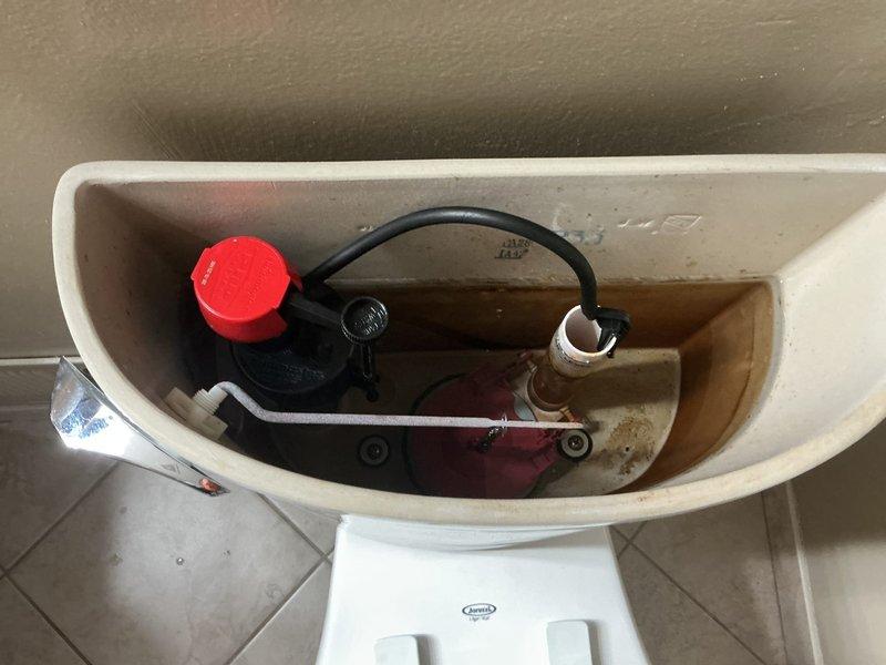 Inspected toilet in master bathroom that was reported as not filling properly. Upon examination, observed mineral buildup and scale on internal tank components, particularly affecting the fill valve mechanism. Disassembled, cleaned, and adjusted the float assembly and flush valve to restore proper water flow and tank filling function. Confirmed toilet now operates correctly with appropriate water levels and complete flush cycle.