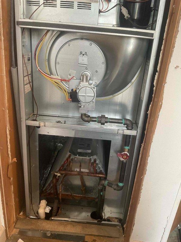 Responded to a gas leak issue in a 3-month-old furnace after utility company detection. Inspected the furnace located in hallway and identified leaking pipe connections with inadequate thread sealant. Repaired by applying proper pipe dope to cast iron fittings and conducted pressure testing to verify resolution of the gas leak.