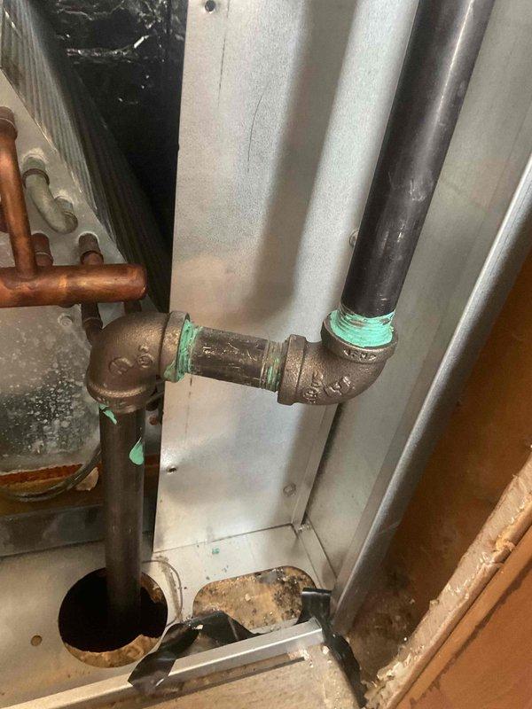 Responded to a gas leak issue in a 3-month-old furnace after utility company detection. Inspected the furnace located in hallway and identified leaking pipe connections with inadequate thread sealant. Repaired by applying proper pipe dope to cast iron fittings and conducted pressure testing to verify resolution of the gas leak.
