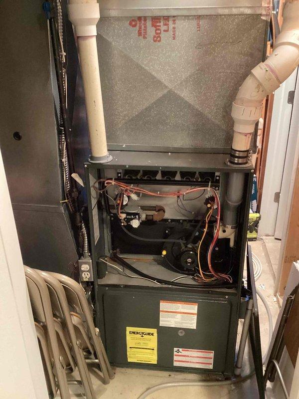 Conducted comprehensive assessment of aging HVAC system including 14-year-old furnace (basement) and AC unit (exterior). Identified plumbing issues requiring saddle valve removal and noted potential replacement of existing Goodman furnace with visible control board and wiring concerns. Documented current ductwork configuration and PVC venting system to prepare accurate replacement options.