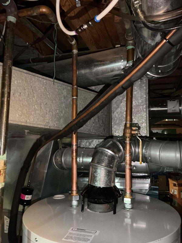 Successfully installed a 50-gallon natural draft gas water heater in the utility room. Completed all necessary copper plumbing connections, including supply lines and ventilation system with proper metal ductwork and fittings. Customer approved installation and paid via credit card.