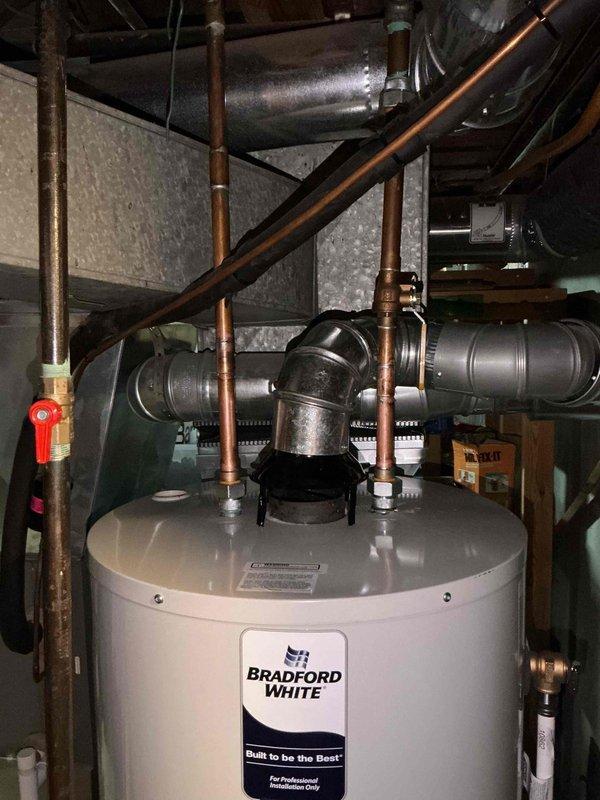 Successfully installed a 50-gallon natural draft gas water heater in the utility room. Completed all necessary copper plumbing connections, including supply lines and ventilation system with proper metal ductwork and fittings. Customer approved installation and paid via credit card.