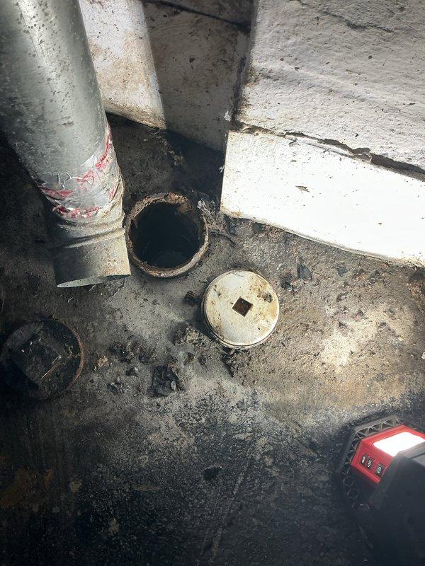 Responded to service call for a clogged drain in basement laundry area that had been problematic for approximately 5 days. Upon inspection, removed floor drain cleanout access cap and identified significant buildup of debris restricting water flow. Successfully cleared the blockage using appropriate snaking equipment, restored proper drainage function, and documented the condition with photos before and during service.
