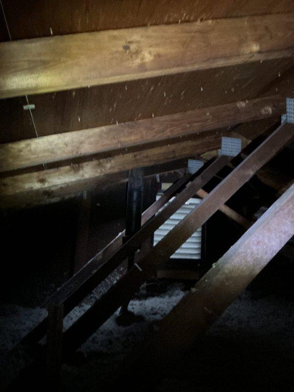 Inspected attic area and identified roof exhaust pipe that had become displaced downward. Successfully repositioned and secured the exhaust pipe to proper height, ensuring proper ventilation function. Verified insulation depth around pipe area and confirmed no additional structural issues present.