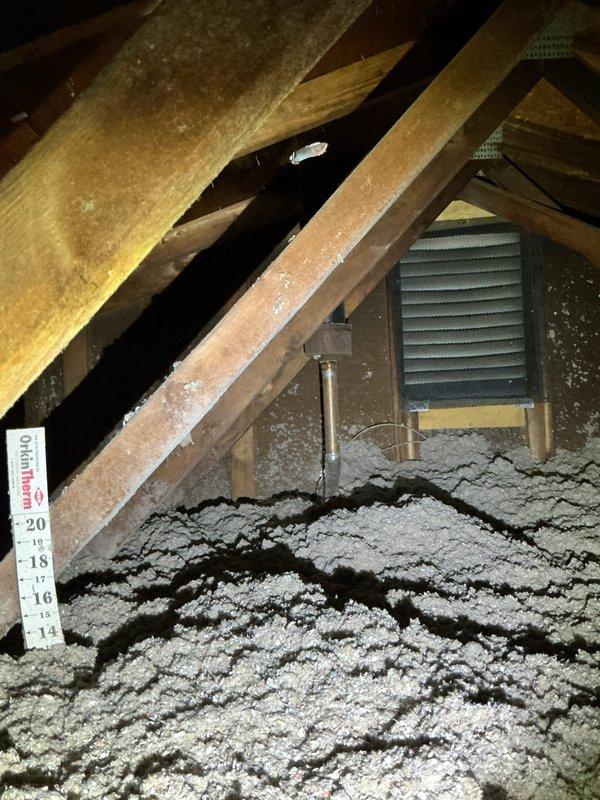 Inspected attic area and identified roof exhaust pipe that had become displaced downward. Successfully repositioned and secured the exhaust pipe to proper height, ensuring proper ventilation function. Verified insulation depth around pipe area and confirmed no additional structural issues present.