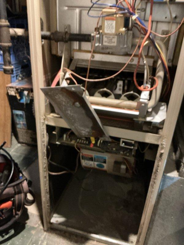 Diagnosed 20+ year old furnace with intermittent operation issues in basement location. Inspection revealed faulty flame sensor and control board requiring maintenance; cleaned sensor and restored electrical connections to restore proper ignition sequence and consistent heating operation.