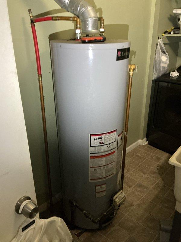 Responded to service call for a 3-4 year old water heater leaking from the bottom in the laundry room. Upon inspection, confirmed tank failure with visible corrosion at base connections and significant mineral buildup around pipe joints. Determined water heater requires replacement due to internal tank rupture, which is not repairable.