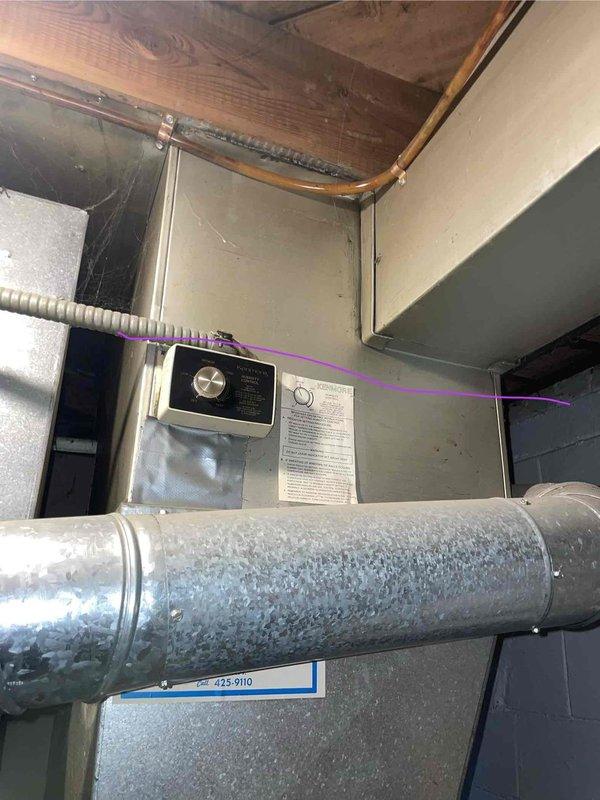 Conducted inspection of 27-year-old furnace with cracked heat exchanger that was not running consistently. Documented system condition in basement installation area, noting exposed ductwork, electrical connections, and overall equipment configuration. Recommended complete replacement due to age and safety concerns of failed heat exchanger.