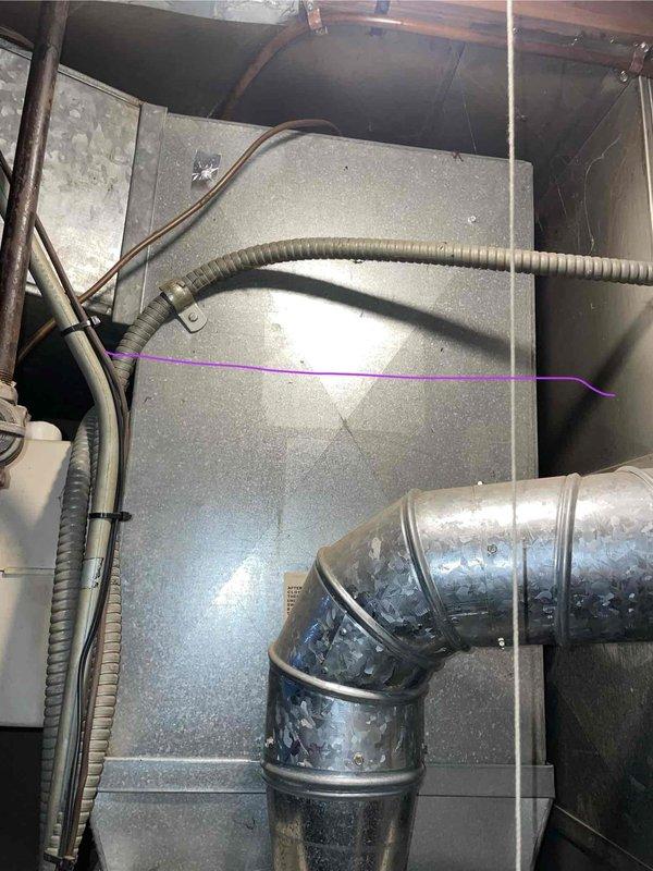 Conducted inspection of 27-year-old furnace with cracked heat exchanger that was not running consistently. Documented system condition in basement installation area, noting exposed ductwork, electrical connections, and overall equipment configuration. Recommended complete replacement due to age and safety concerns of failed heat exchanger.