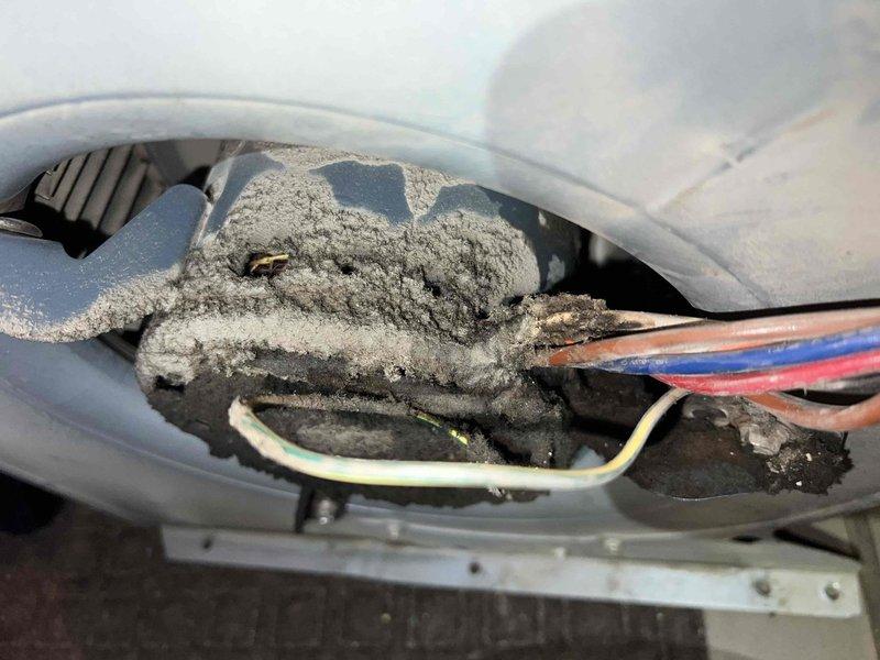 Performed a second opinion assessment on a 25-year-old natural gas furnace located in the utility room. Visual inspection revealed excessive dust accumulation throughout the system components and electrical connections, confirming the previously diagnosed cracked heat exchanger. Documented findings with detailed photographs of the deteriorated heat exchanger and surrounding components.