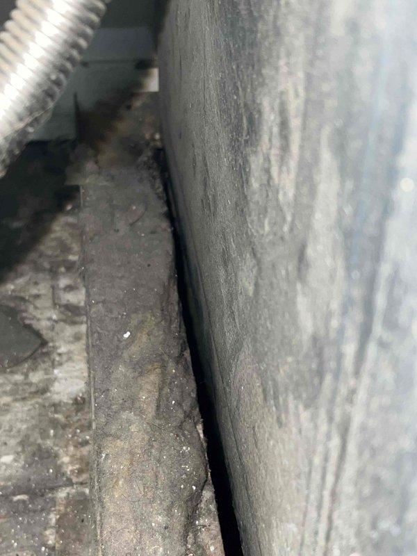 Performed a second opinion assessment on a 25-year-old natural gas furnace located in the utility room. Visual inspection revealed excessive dust accumulation throughout the system components and electrical connections, confirming the previously diagnosed cracked heat exchanger. Documented findings with detailed photographs of the deteriorated heat exchanger and surrounding components.