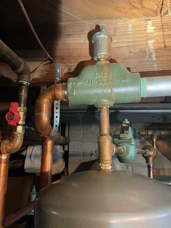 Replaced leaking 1-1/4" dielectric union and associated pipe at the TACO Air Scoop assembly. Installed new 1-1/4" nipple and performed complete air bleeding procedure on boiler system to restore proper operation and eliminate leakage at severely corroded connection point.
