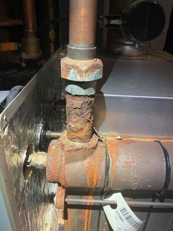 Replaced leaking 1-1/4" dielectric union and associated pipe at the TACO Air Scoop assembly. Installed new 1-1/4" nipple and performed complete air bleeding procedure on boiler system to restore proper operation and eliminate leakage at severely corroded connection point.