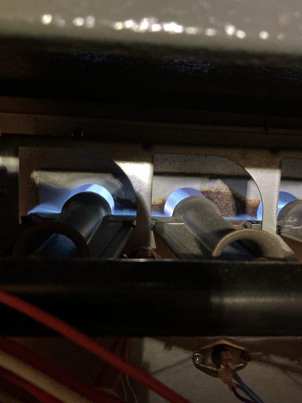 Performed comprehensive tune-up on gas furnace located in basement. Inspection revealed functional burner assembly with proper flame pattern, though some rust was present on heat exchanger surfaces. Checked and verified proper operation of electrical components, including control board connections, motor assembly, and safety systems. Inspected associated components including humidifier, thermostat, and hot water tank as part of standard maintenance protocol.