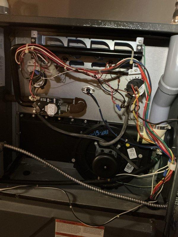 Performed comprehensive tune-up on gas furnace located in basement. Inspection revealed functional burner assembly with proper flame pattern, though some rust was present on heat exchanger surfaces. Checked and verified proper operation of electrical components, including control board connections, motor assembly, and safety systems. Inspected associated components including humidifier, thermostat, and hot water tank as part of standard maintenance protocol.