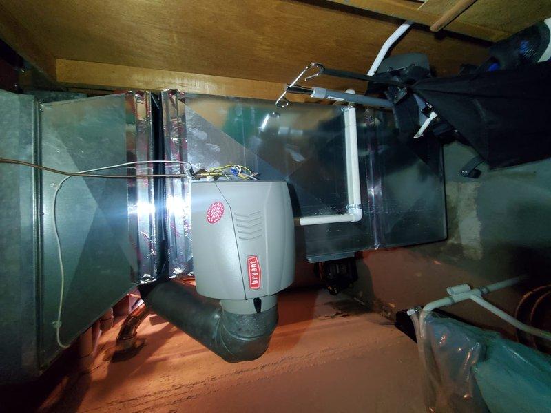Completed Gold Furnace Inspection on a functioning residential furnace under 10 years old located in basement. Inspected humidifier mounted on ductwork, verified proper connections and installation. Checked White-Rodgers thermostat operation, confirmed system functionality with temperature reading at 72°F.