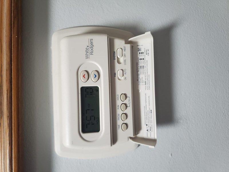 Completed Gold Furnace Inspection on a functioning residential furnace under 10 years old located in basement. Inspected humidifier mounted on ductwork, verified proper connections and installation. Checked White-Rodgers thermostat operation, confirmed system functionality with temperature reading at 72°F.