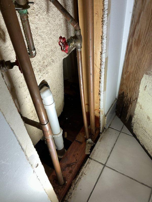 Responded to a water leak service call in the basement where copper supply lines were showing signs of corrosion with green patina at connection points. Upon inspection, identified moisture damage to adjacent wooden framing and installed a new shut-off valve with red handle to isolate the affected section of plumbing. Completed repairs to prevent further water damage and ensure proper system functionality.