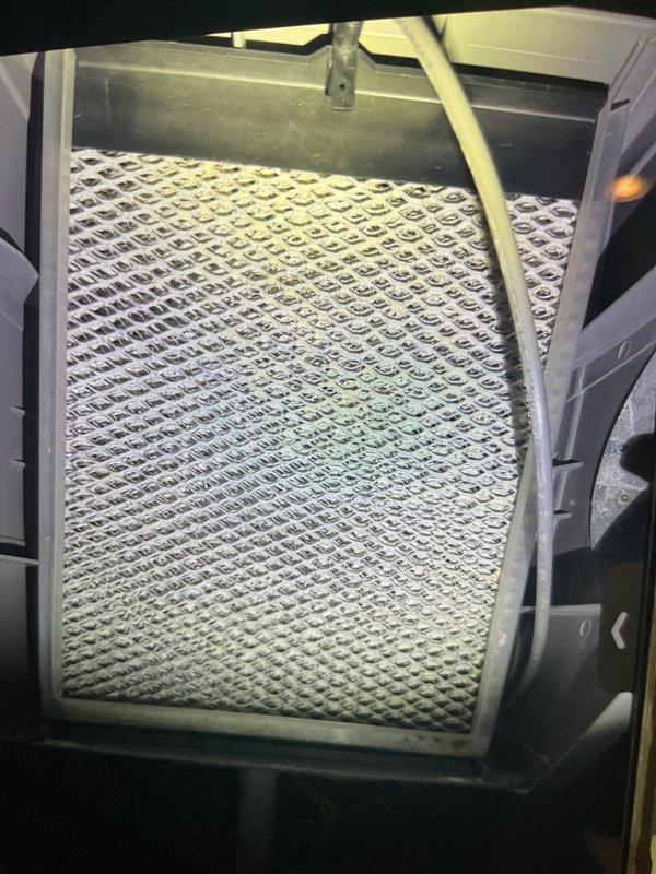 Performed routine gold furnace inspection on 12-year-old furnace system located in basement. Inspected and documented condition of air filtration system with aluminum mesh filter and verified proper installation within housing. Noted Bradford White "Defender Safety System" water heater with appropriate copper plumbing connections and functional PVC venting in good working condition with current approval certification.