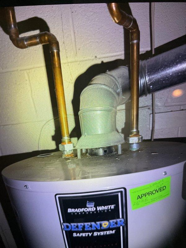 Performed routine gold furnace inspection on 12-year-old furnace system located in basement. Inspected and documented condition of air filtration system with aluminum mesh filter and verified proper installation within housing. Noted Bradford White "Defender Safety System" water heater with appropriate copper plumbing connections and functional PVC venting in good working condition with current approval certification.