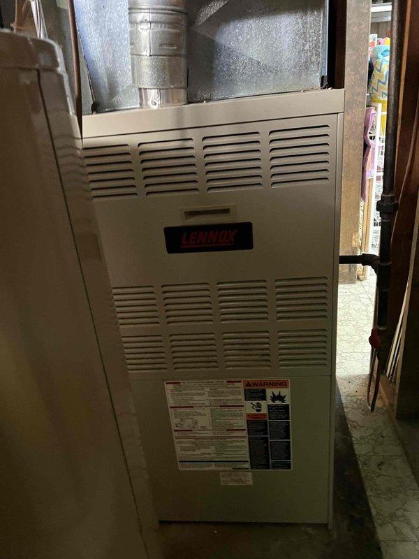 Responded to no-heat call for 32-year-old Lennox furnace with burning odor. Diagnosed cracked heat exchanger causing system failure, evidenced by visible fracture in combustion chamber and confirmed through visual inspection. Due to age of unit and safety concerns, recommended complete system replacement as repair not viable.