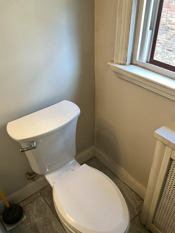 Responded to service call for continuously running upstairs toilet and identified a crack in the main sewer stack causing leakage. Documented improper pitch on customer's floor drain and photographed both the toilet installation and basement plumbing configuration for reference. Previous estimate for floor break repair was noted and cross-referenced with job #1148034.