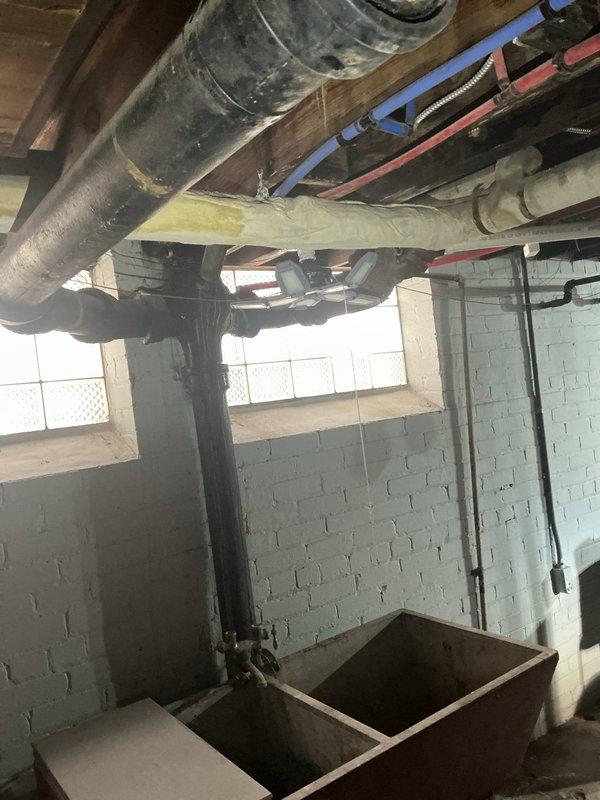 Responded to service call for continuously running upstairs toilet and identified a crack in the main sewer stack causing leakage. Documented improper pitch on customer's floor drain and photographed both the toilet installation and basement plumbing configuration for reference. Previous estimate for floor break repair was noted and cross-referenced with job #1148034.