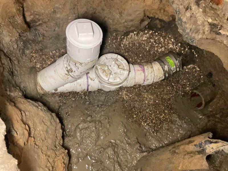 Completed installation of a new sump pit with storm conversion to address non-functioning sump pump. Excavated area for proper drainage system, installed PVC piping with T-junction and clean-out access point, and reconnected the backwater valve to ensure proper water management and basement protection.