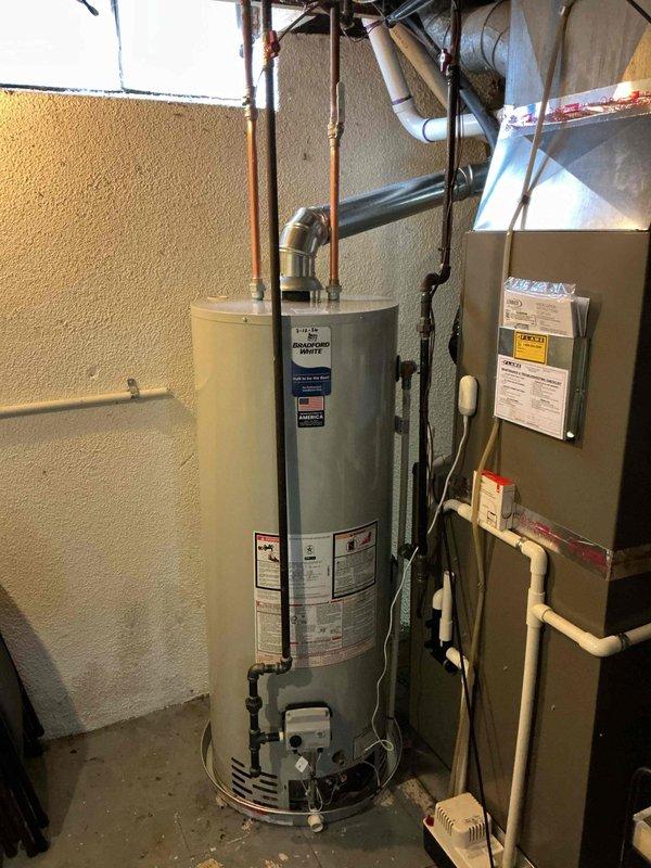 Successfully installed a 50-gallon standard hot water tank with proper copper pipe connections for hot and cold water lines. Installed a drip pan with alarm as requested and verified all plumbing connections for leaks. Completed mechanical reconnection with appropriate venting system to ensure safe and efficient operation.