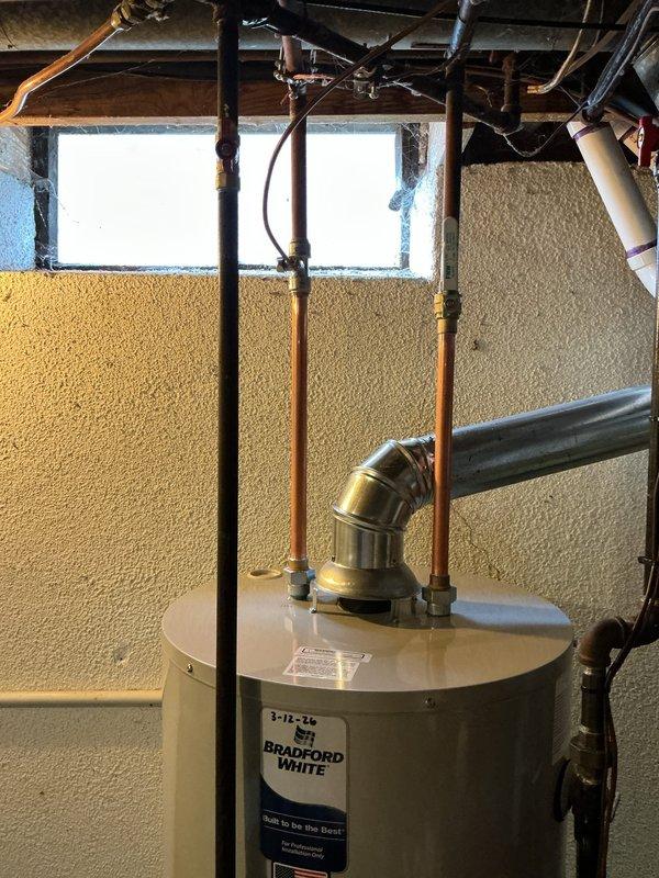 Successfully installed a 50-gallon standard hot water tank with proper copper pipe connections for hot and cold water lines. Installed a drip pan with alarm as requested and verified all plumbing connections for leaks. Completed mechanical reconnection with appropriate venting system to ensure safe and efficient operation.