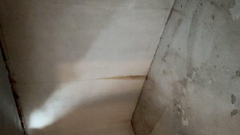 Diagnosed and serviced sump pump system in basement of 40-year-old home. Inspected PVC discharge pipe configuration and surrounding wall structure for moisture damage. Completed maintenance service to restore proper sump pump operation.