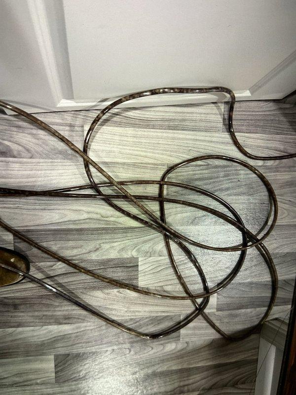 Performed tune-up service on heat pump system. Unclogged condensate pump hose that was causing drainage issue and replaced deteriorated discharge tubing. System now operating properly with restored condensate drainage.