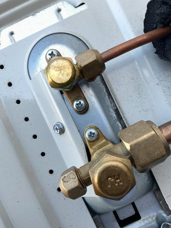 Performed diagnostic assessment on mini split system reported to be cycling inconsistently. Inspected refrigerant line connections and service valves (identified with "CH" marking) at the outdoor unit. Verified proper installation of copper lines and insulation integrity. System functionality was confirmed with normal operation parameters.