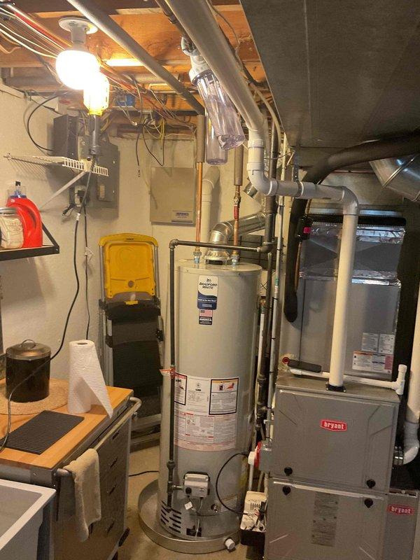 Completed installation of a 40-gallon Icon System water heater in basement location. Unit features temperature control panel with safety settings and pilot light system. Installation included proper connection to existing plumbing infrastructure and verification of proper operation alongside Bryant furnace system.