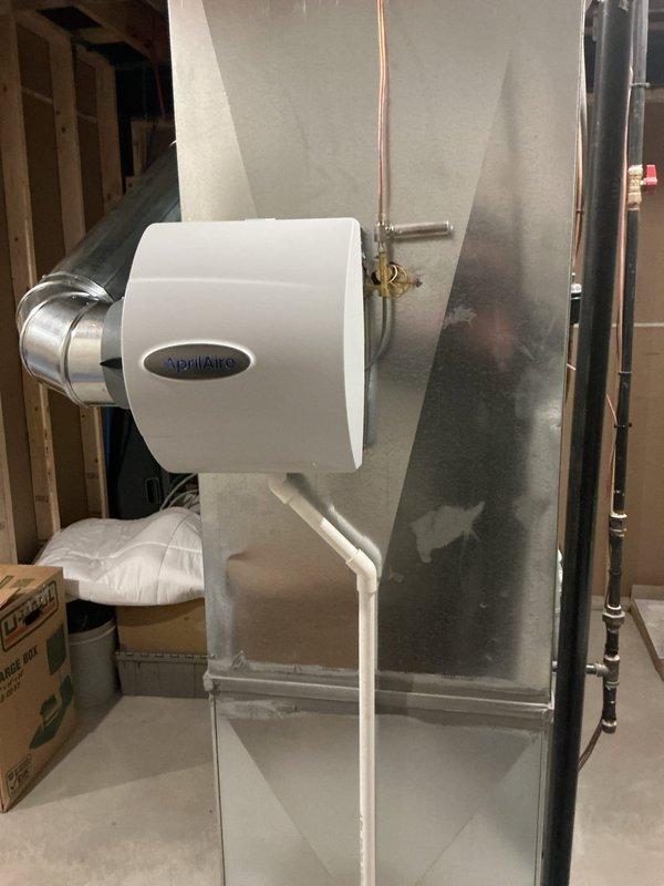 Successfully installed an AprilAire bypass humidifier on the existing HVAC system in the basement utility area, including proper mounting to the metal ductwork, connection to water supply, and drainage setup. System was tested and is functioning as designed to improve indoor air quality.