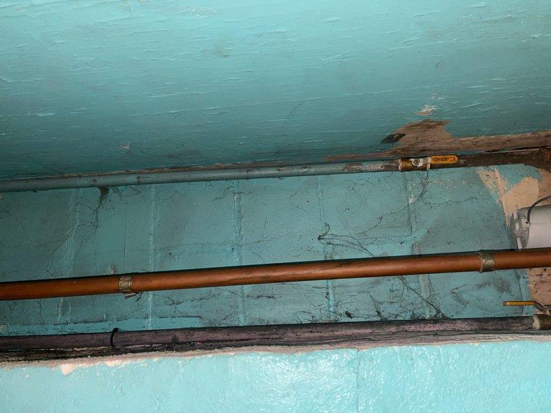 Installed a ground strap on the water meter to establish proper electrical grounding. Existing plumbing system consisted of copper pipes with various brass fittings showing normal patina consistent with age. Completed installation ensures electrical safety compliance for the household water system.