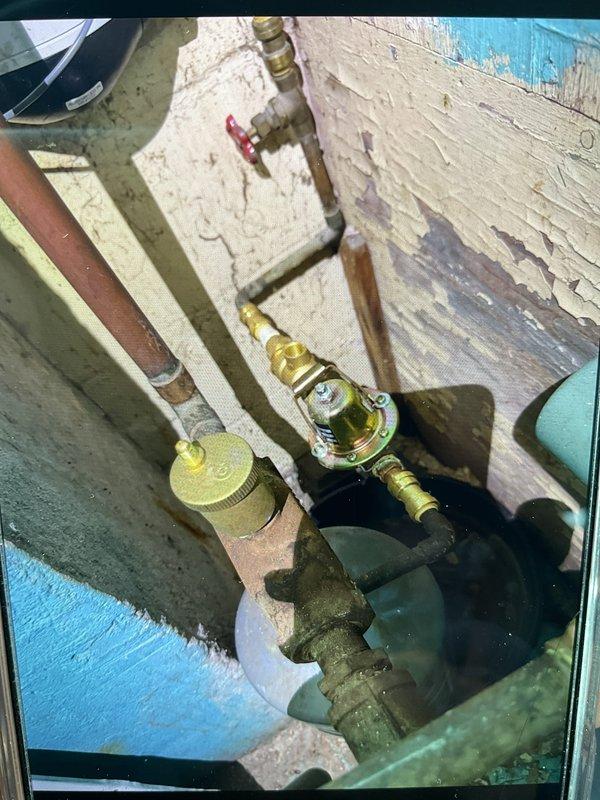 Performed boiler inspection and certification. System is functioning properly in a confined installation location with copper/brass plumbing components showing normal aging. Noted that future service may require technician able to work in tight spaces.