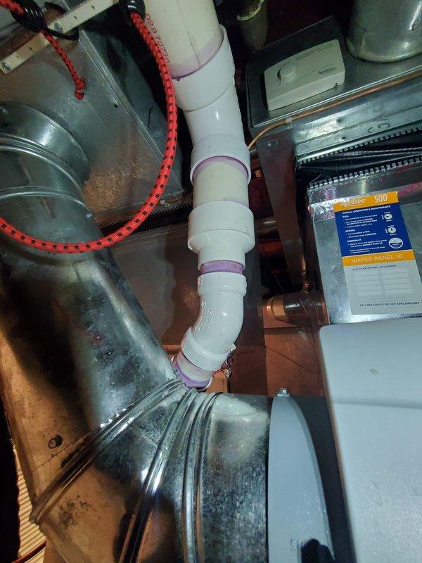 Repaired a condensation drain line leak on a three-year-old 90% furnace located in the basement. Inspection revealed PVC drain piping with proper purple primer at joints was intact but leaking at connection points; resealed all joints and confirmed proper drainage. System is now operating correctly with no moisture issues.
